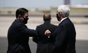 Republican leaders in masks!Vice President Mike Pence, right, is greeted with an elbow bump by Arizona governor Doug Ducey, left, as he arrives today in Phoenix to discuss the record surge in coronavirus cases.