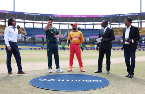 Travis Head flips the coin as Sikandar Raza calls tails before Australia and Zimbabwe meeting at the T20 World Cup