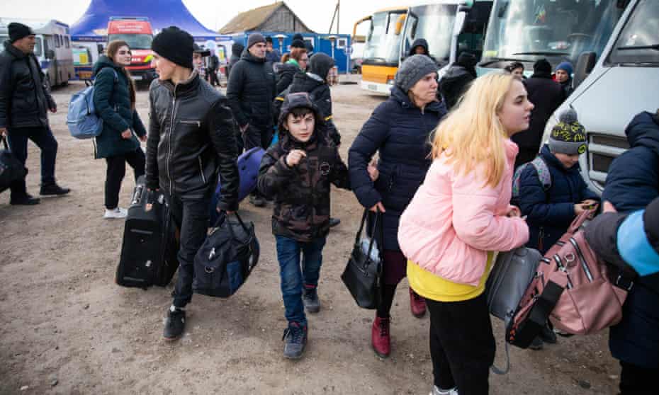 Ukrainian refugees board a bus near the Palanca border crossing in southeastern Moldova.