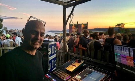 Sound engineer Shan Hira behind the mixing desk at a Liam Gallagher show in Tasmania in 2017.