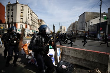 French gendarmes run amid clashes during a protest by high school students near the Lycee Berthelot high school in Aubervilliers