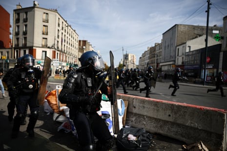 French gendarmes run amid clashes during a protest by high school students near the Lycee Berthelot high school in Aubervilliers near Paris as part of nationwide protests to demand the hiring of substitute teachers, increased resources and better learning conditions, as more than 400 schools remain closed following days of student protests that have escalated into violence in some places.