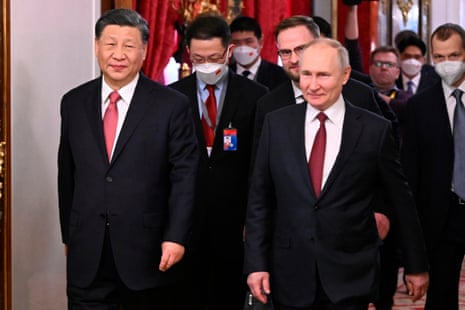 Russian President Vladimir Putin and Chinese President Xi Jinping enter a hall for their talks at The Grand Kremlin Palace.