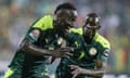Senegal's forward Famara Diedhiou (L) celebrates after scoring.