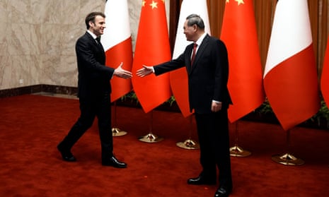 France’s President Emmanuel Macron, center left, is welcomed by Chinese Premier Li Qiang, prior to a meeting at the Great Hall of the People, in Beijing, China, Thursday, 6 April 2023.