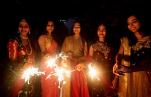 Bhopal, India. Indian women hold sparklers in Uttar Pradesh