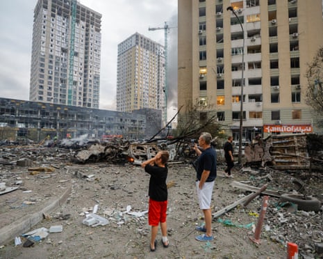Local residents react at the site of a Russian strike on a residential area in Kyiv, Ukraine.
