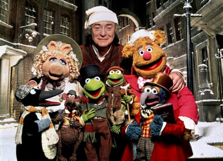 Michael Caine as Ebenezer Scrooge in The Muppet Christmas Carol, with several of the Muppet cast
