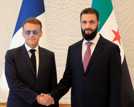 Emmanuel Macron and Ahmed al-Sharaa shake hands