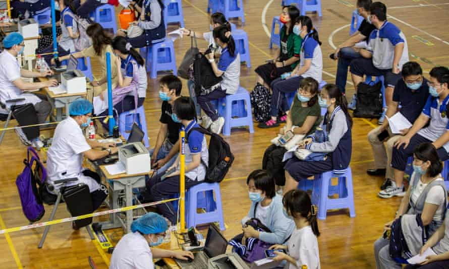 High school students in Nanjing wait in line to register for a Covid vaccination.