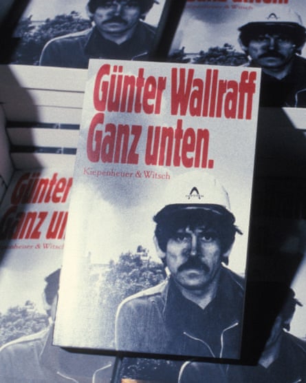 Display of Ganz Unten books with a black and white photo of Günter Wallraff dressed as a Turkish migrant wearing a hard hat