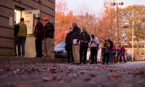 Voters line up to cast their ballots at the start of early voting in Atlanta, Georgia, on 26 November.