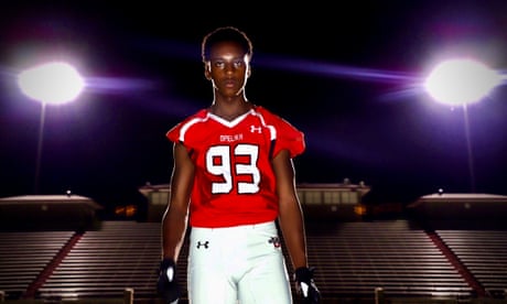Teen boy in a football uniform