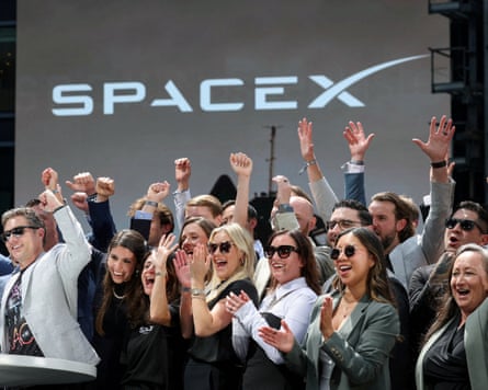 SpaceX leadership members and guests celebrate on a balcony at the Nasdaq MarketSite