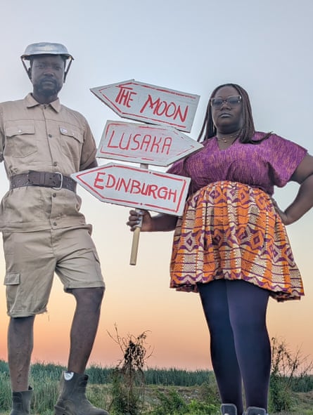 A man and a woman with signposts to Edinburgh, Lusaka and the moon
