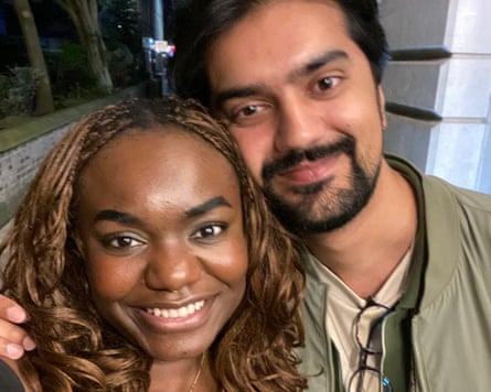 A selfie of a woman and man with arm round her