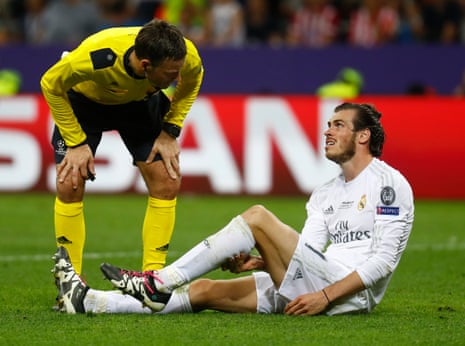 Gareth Bale looks in pain as he talks to Clattenburg.