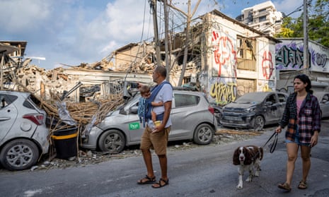 Israelis inspect the rubble of a building after it was hit by a rocket fired from the Gaza Strip.