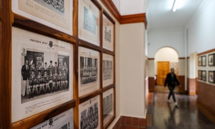 Pictures of school rugby teams line the walls of a corridor