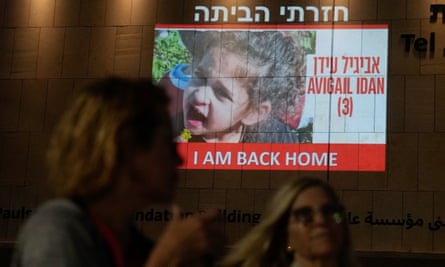 People walk past television footage announcing Abigail Edan’s release