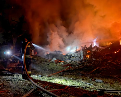Ukrainian rescuers work at the site of a Russian attack on a residential area in Zaporizhzhia, Ukraine.