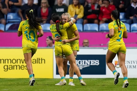 Australia’s Maddison Levi (centre right) celebrates with rugby sevens teammates after winning gold.