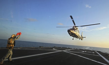 A Chinese military helicopter flies off the deck of Singaporean frigate during joint exercises in the South China Sea in May. 