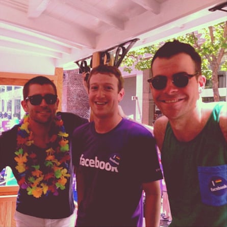 three men smiling, wearing Facebook pride gear.