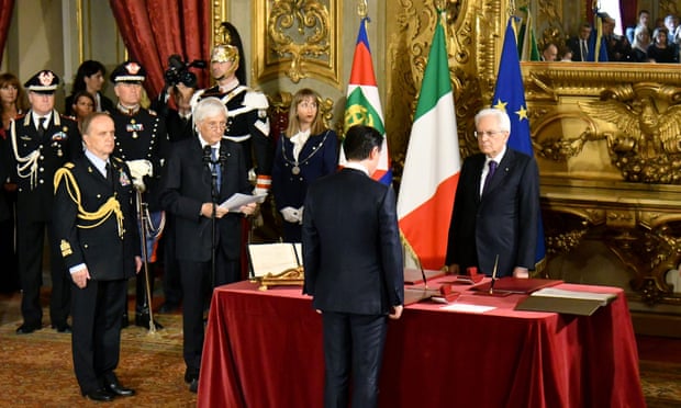 The new prime minister, Giuseppe Conte, stands in front of the president, Sergio Mattarella during the swearing-in ceremony in Rome.