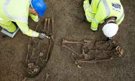 A set of Roman burials being carefully excavated by archaeologists