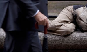 A businessman walking by a homeless person