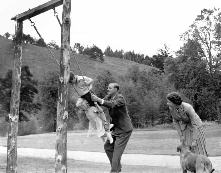 Prince Charles and Princess Anne being pushed on a swing by their father in the grounds of Balmoral.