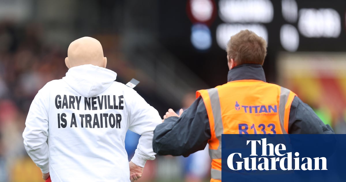 Pitch invaders disrupt League Two game in Gary Neville is a traitor' flag protest
