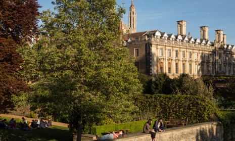 Students relax on the garden walls of Trinity Hall, Cambridge.