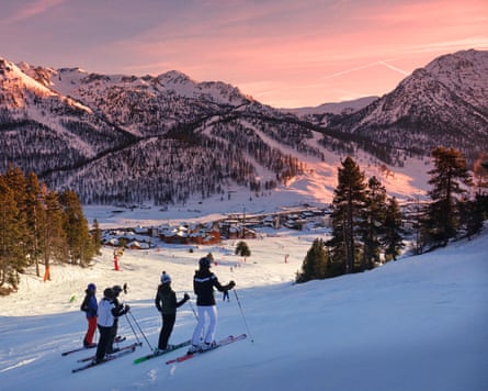 Montgenevre ski resort - four skiers looking at striking pink sunset