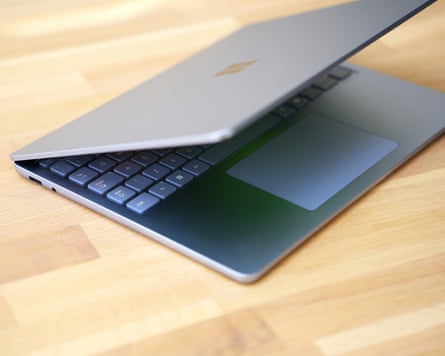 The Surface Laptop 13in half open on a table.