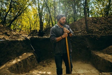 Volkov standing in the middle of an archaeological dig surrounded by mature trees on Khortytsia island.