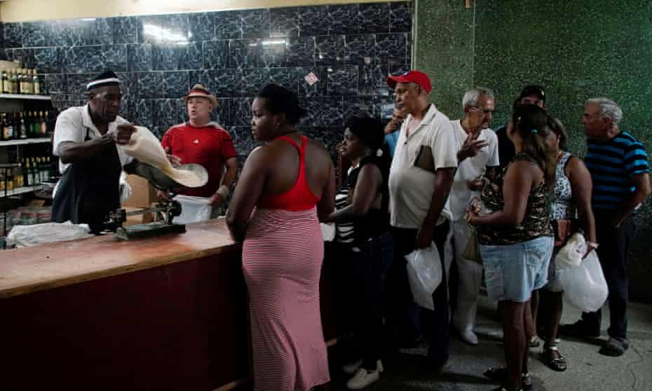 People wait in line to buy rice in a state store in downtown Havana.