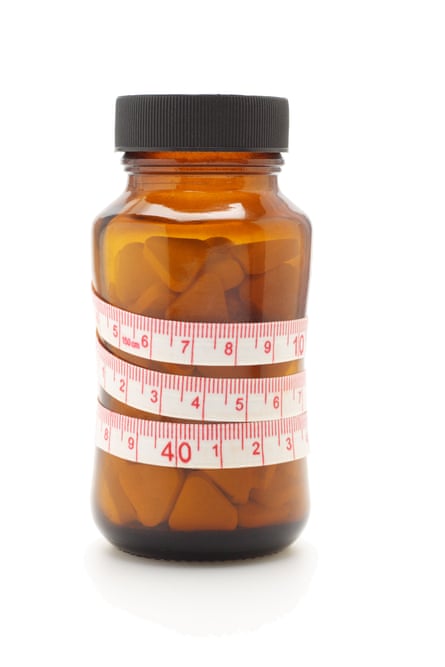 diet pill bottle with tape measure around it