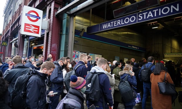 Commuters queue for the underground to resume at Waterloo station in London