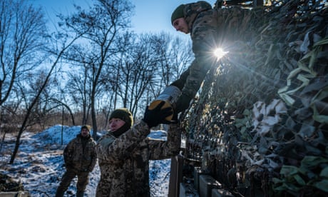 Ukrainian soldiers load ammunition onto their vehicle before going to the frontline.