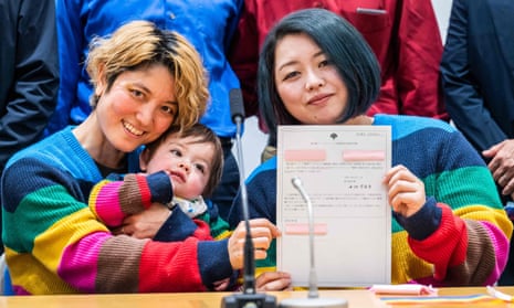 Mamiko Moda (left), her partner Satoko Nagamura, and their son, with their same-sex partnership certificate at press conference on Tuesday.