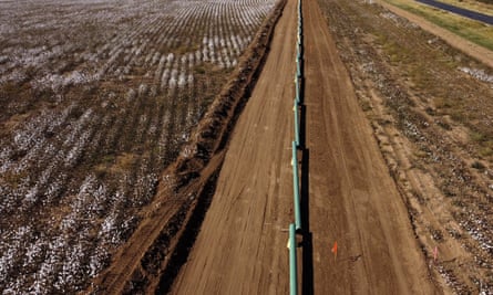 Pipes sit in a cotton field waiting to be installed for new oil pipelines in Lenorah, Texas, Friday, Oct. 15, 2021. The frenetic search for more gas and oil is happening just as President Biden and world leaders are promising to cut methane emissions across the world. (AP Photo/David Goldman)