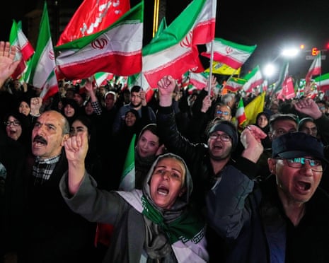Pro-government supporters chant slogans and wave Iranian flags during a rally in Tehran, Iran