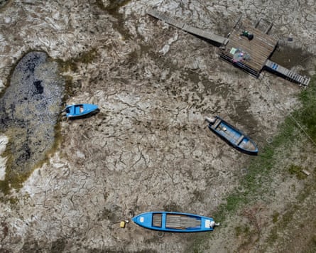 Top-down photograph shows boats laying on the dried Danube riverbed.