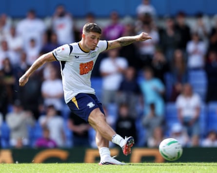 The Preston midfielder Alfie Devine scores a penalty during his team’s shootout win at home to Huddersfield in the first round of the Carabao Cup.