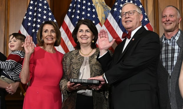 Susan Wright holds a Bible as her husband, Ron Wright, is sworn into Congress by Speaker Nancy Pelosi. Ron Wright died in February.
