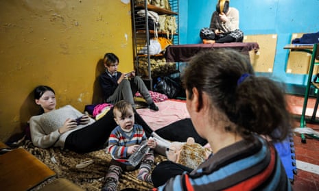 A family pass time in a bomb shelter in Kyiv.