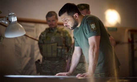 Ukrainian president Volodymyr Zelenskiy is briefed by soldiers in July this year