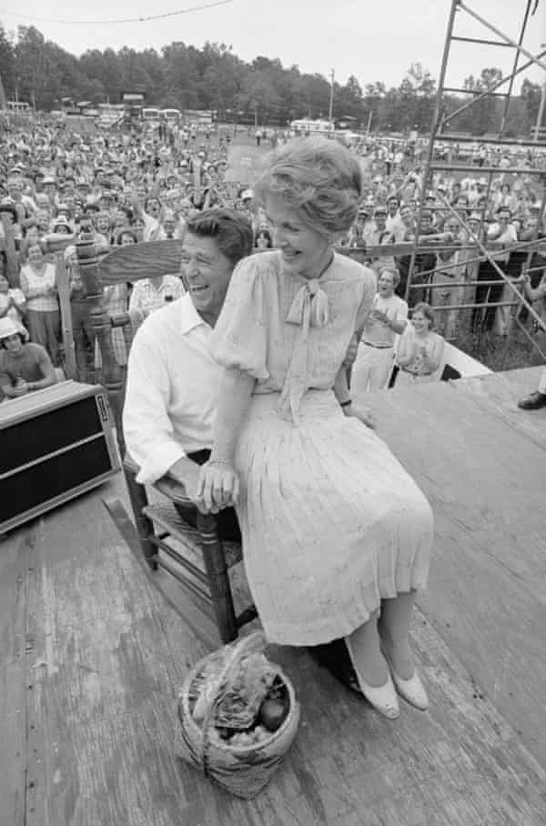 Ronald Reagan and wife Nancy share a chuckle as they try a rocking chair presented during their visit to the Neshoba County Fair.